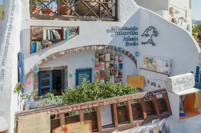 Cozy and grandiose library exterior with books and plants, showcasing a magical bookstore ambiance from around the world. Cozy and grandiose library exterior with books and plants, showcasing a magical bookstore ambiance from around the world.